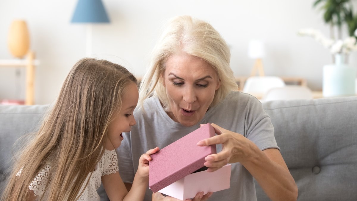 Grandmother opening present from grandaugter
