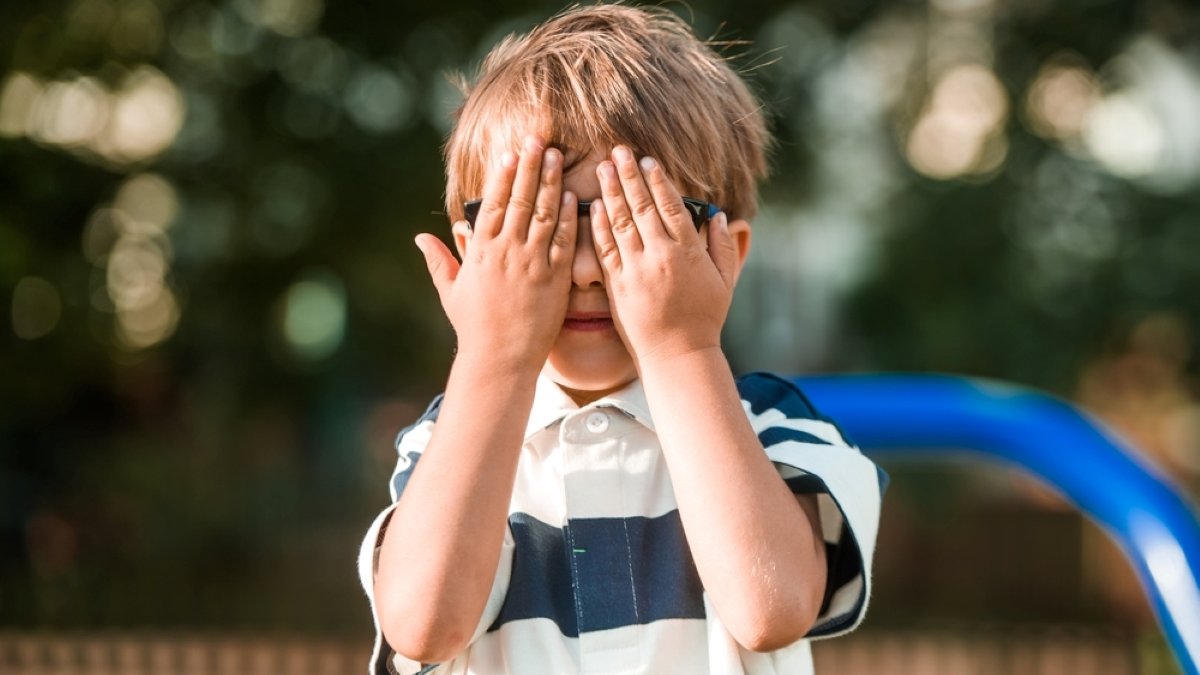 little funny boy plays hide and seek