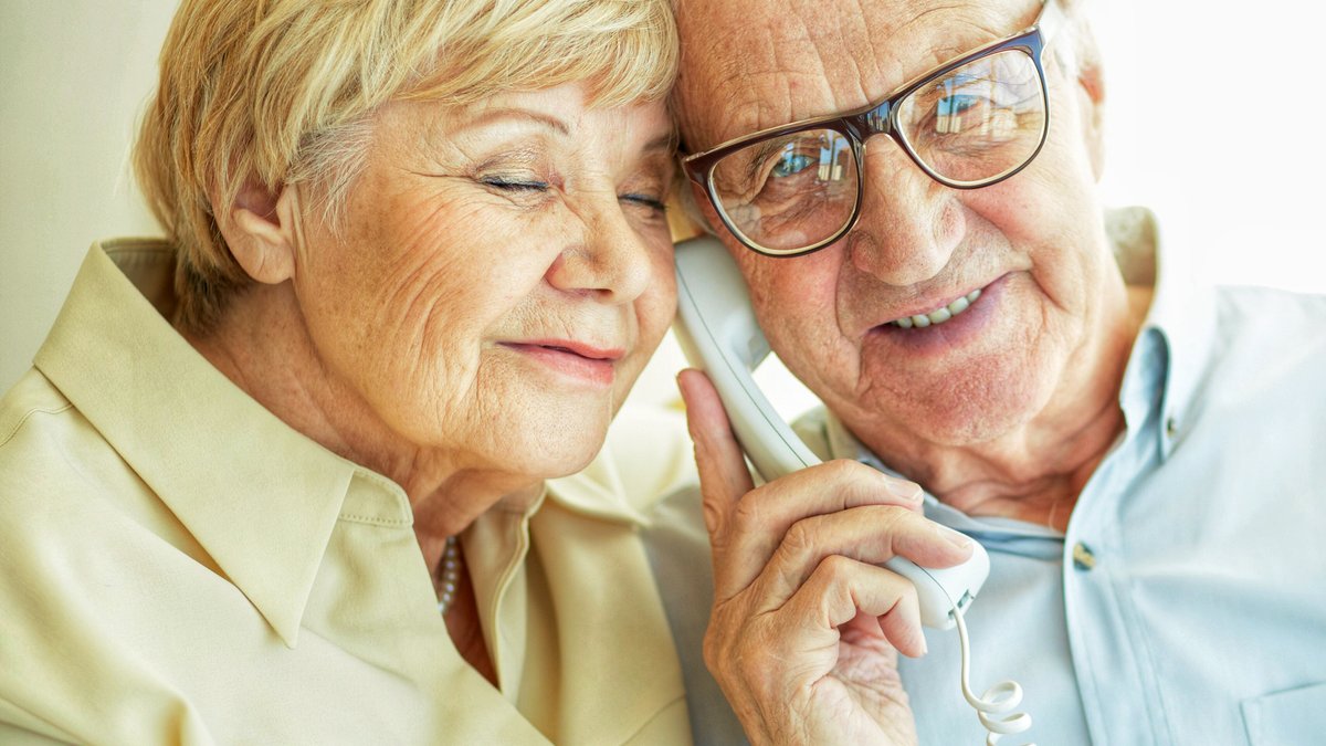 Elderly couple on phone