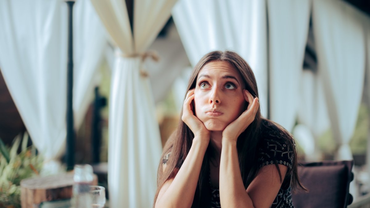 Unhappy young woman at event