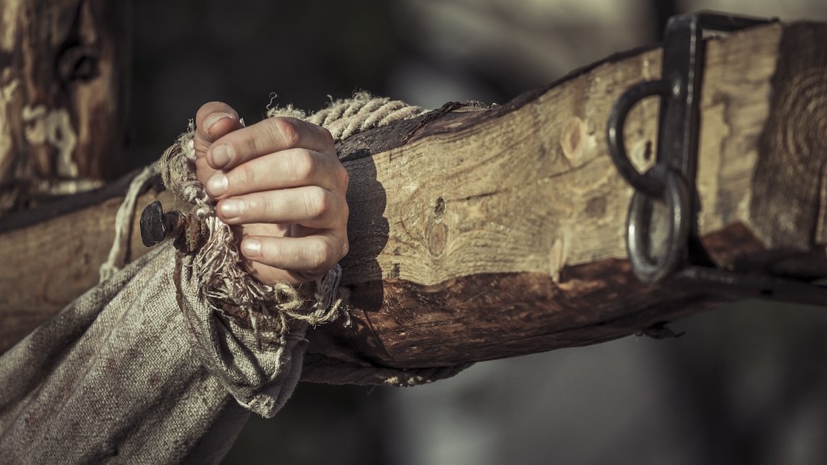 A hand nailed to a cross