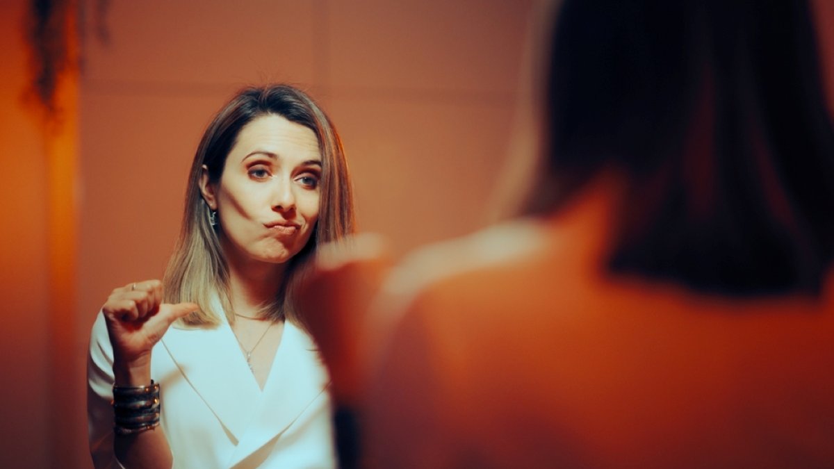Vain Woman pointing to Herself Looking in the Mirror