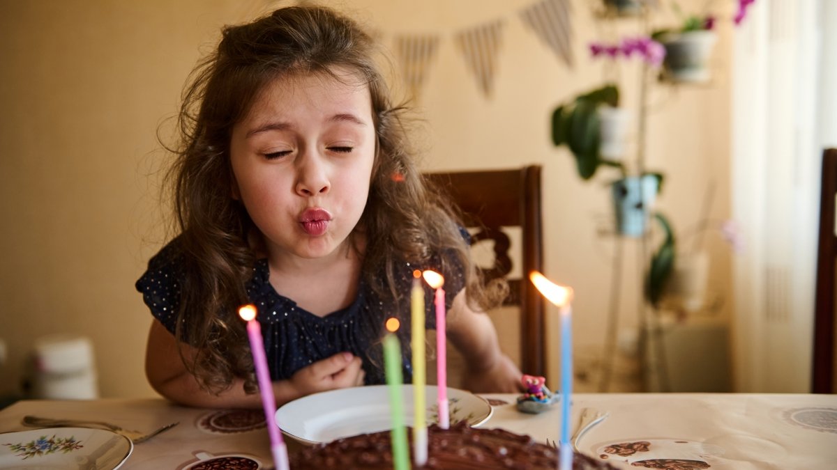 Girl blowing out candles