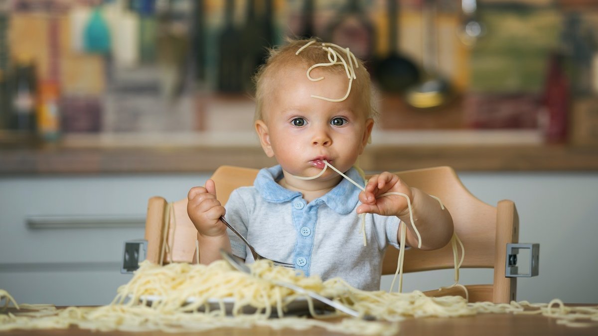 italian baby eating pasta