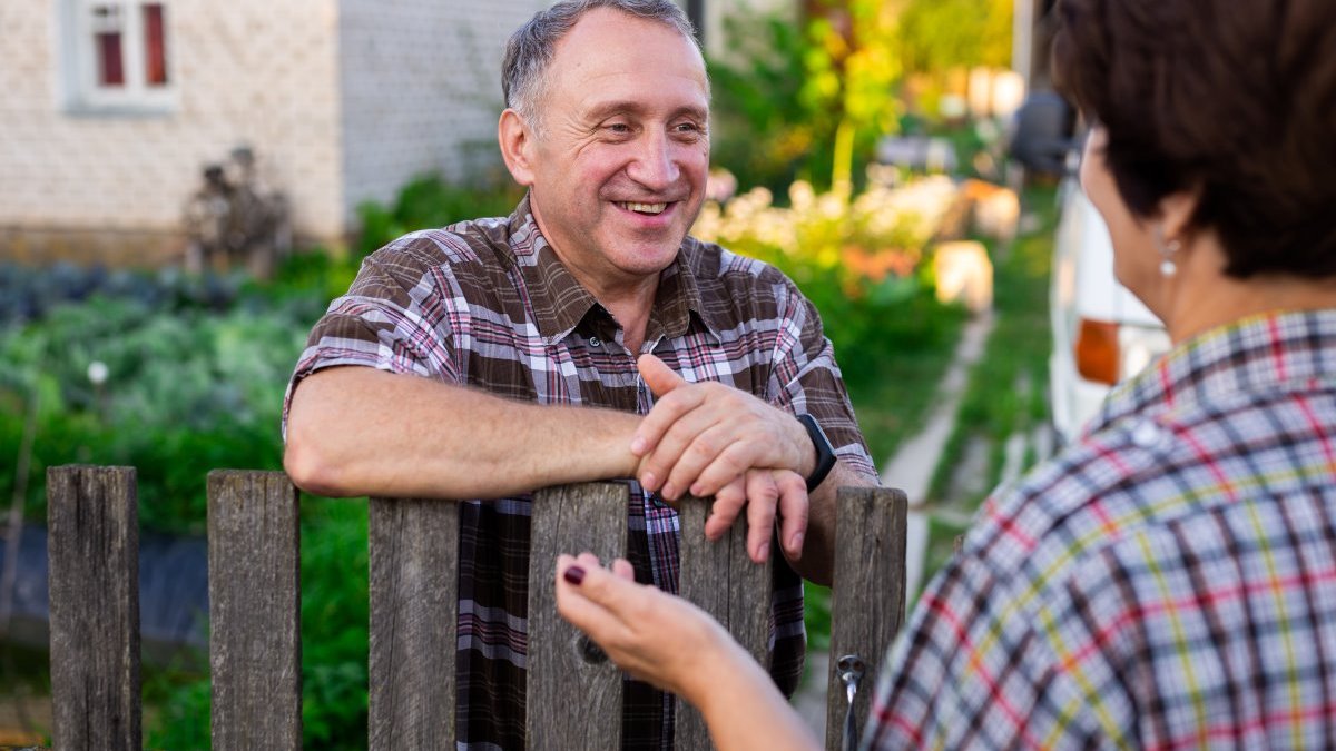 Neighbors talking across fence
