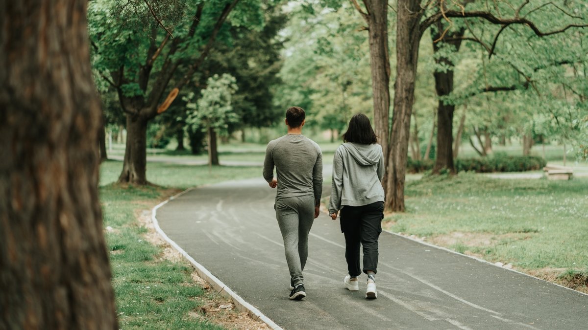 Sport couple walking on the path in the park