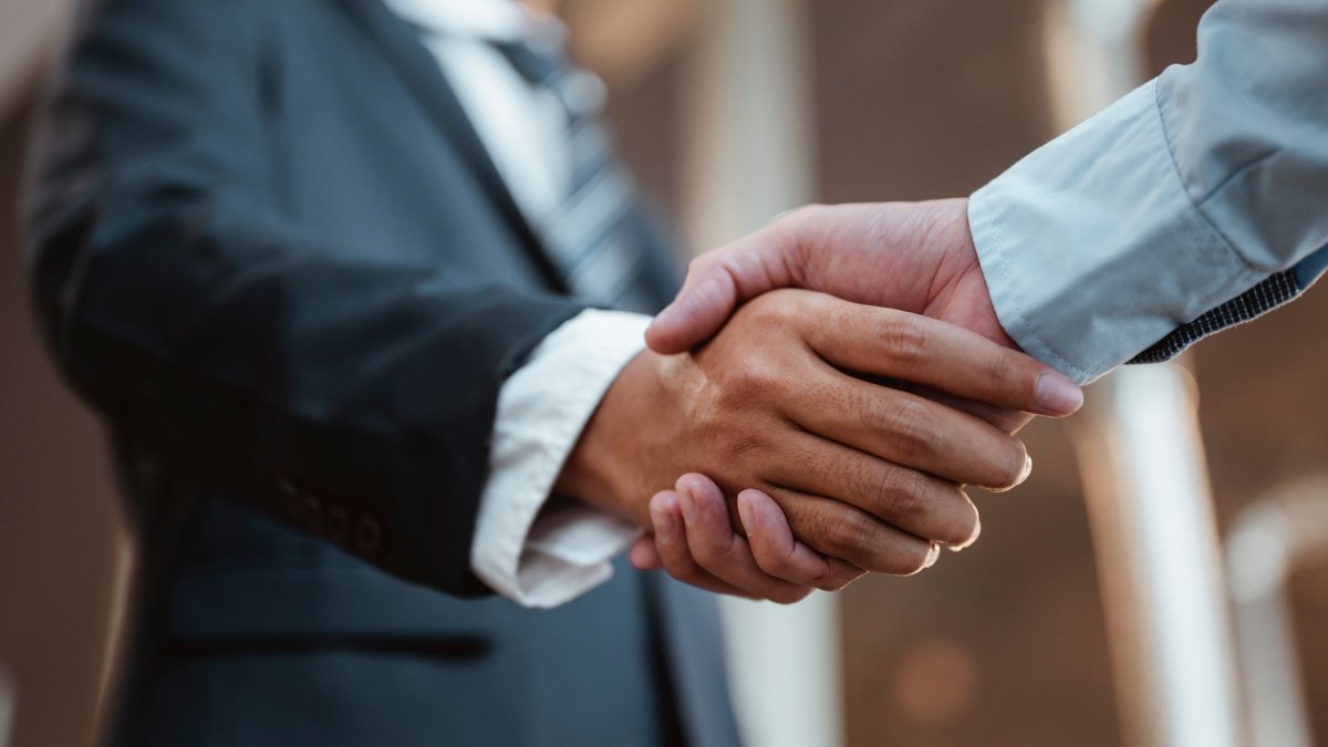 Commander handshaking new employee congratulating with starting a new job
