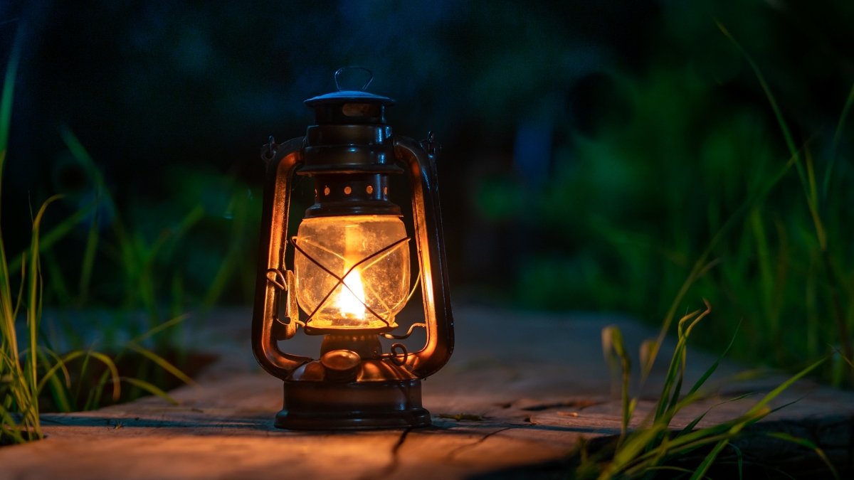 antique oil lamp on the old wooden floor in the forest at night camping atmosphere