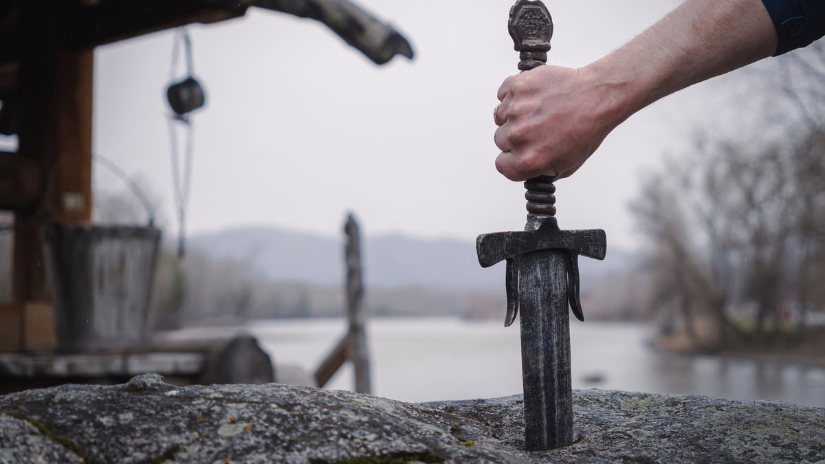 famous-sword-excalibur-of-King-Arthur-stuck-in-the-rock.-Edged-weapons-from-the-legend-Pro-king-Arthur.-.jpg