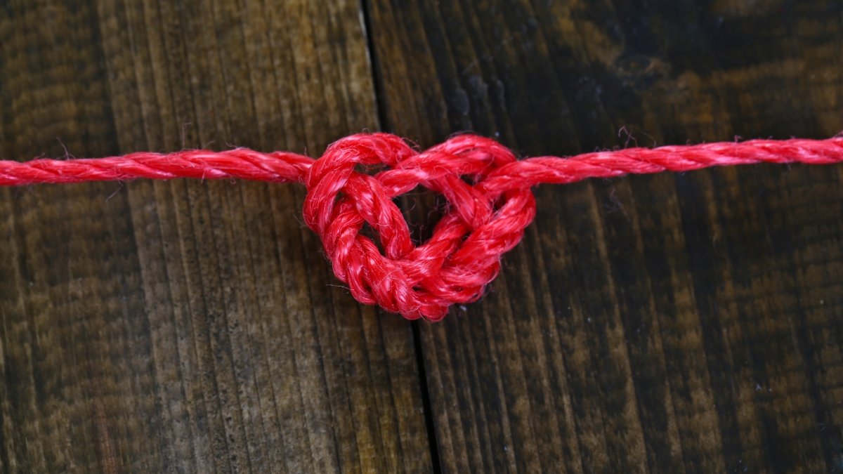 Heart shape from rope, on wooden background