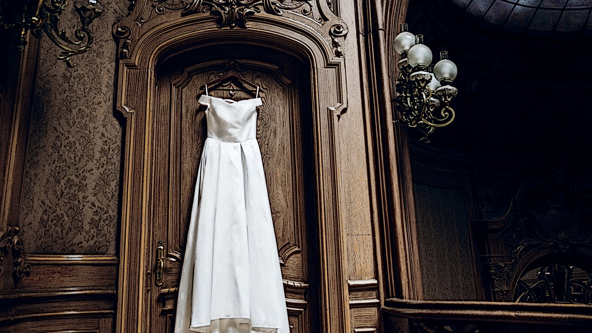WEDDING DRESS HUNG ON DOOR