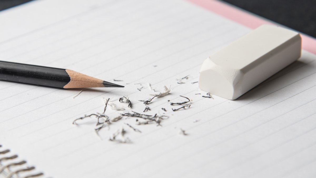white eraser and pencil on notebook,mistake concept