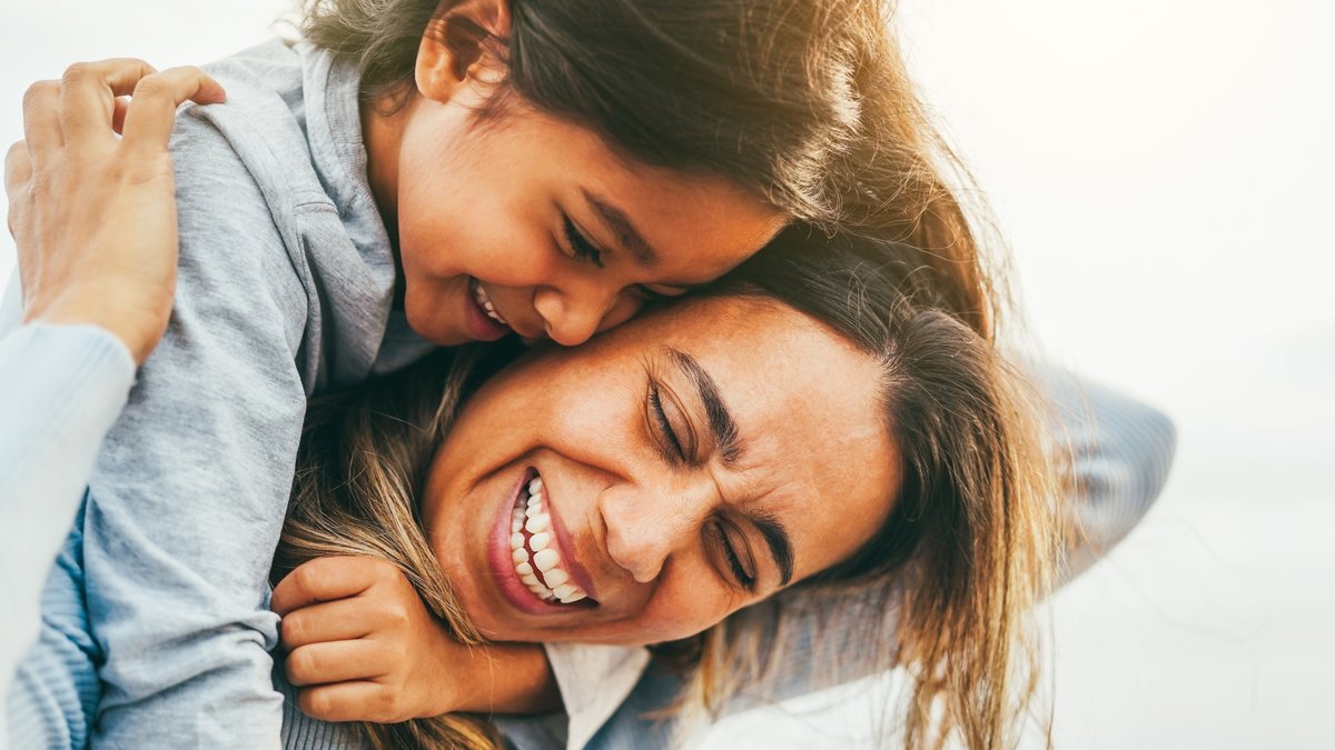 Happy mom with daughter on back