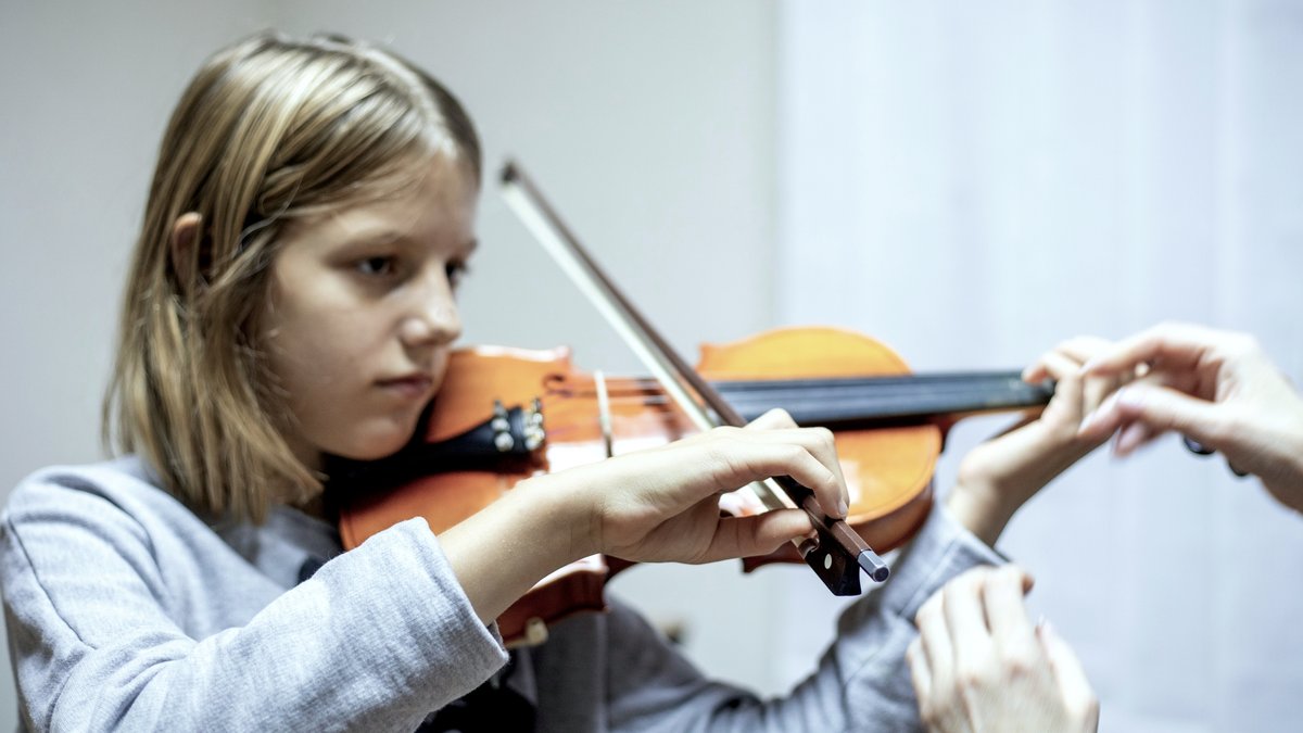 Teacher working with violin student