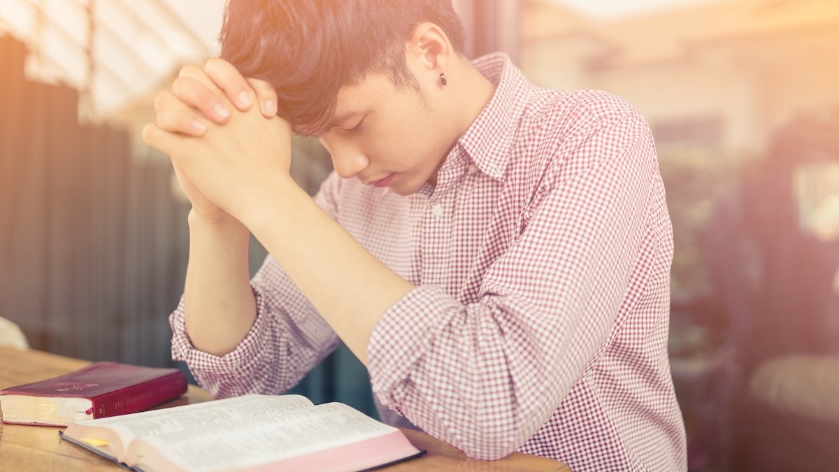 young man prayer bible