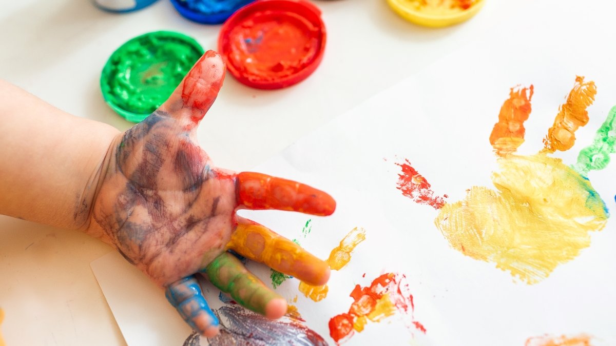 Close up of colored hand print on white background
