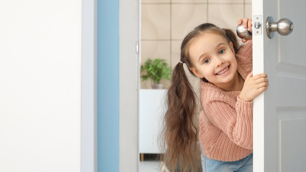 Cute little girl looking out the door