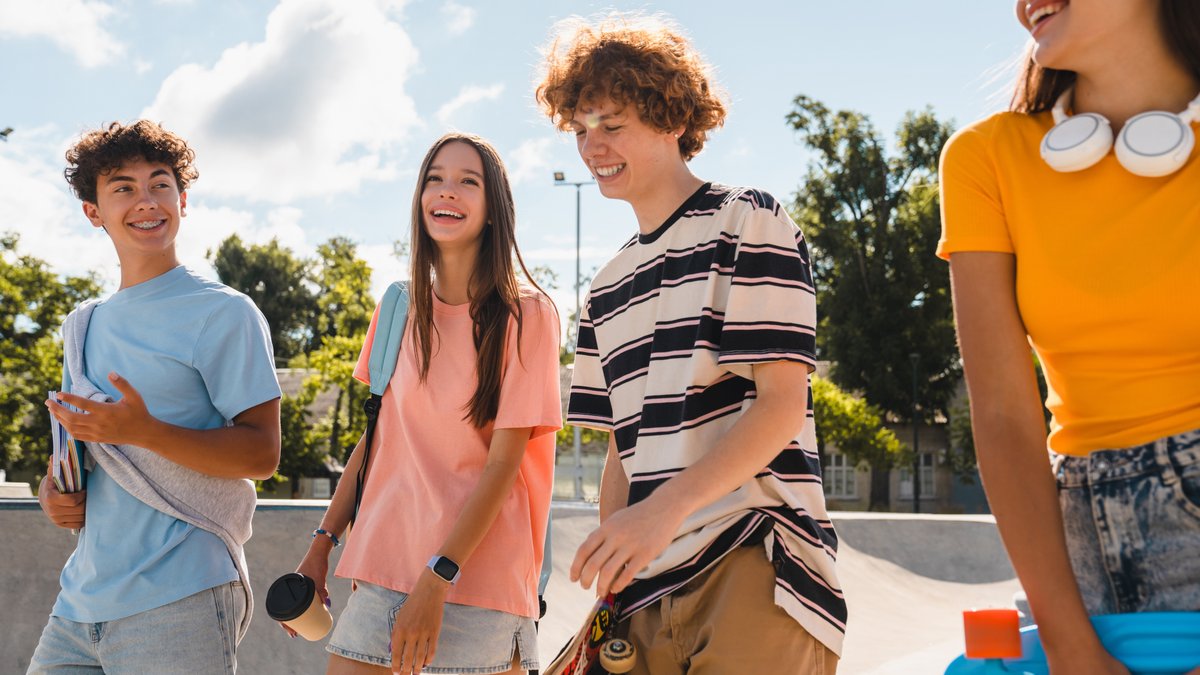 teens hanging out skateboard park