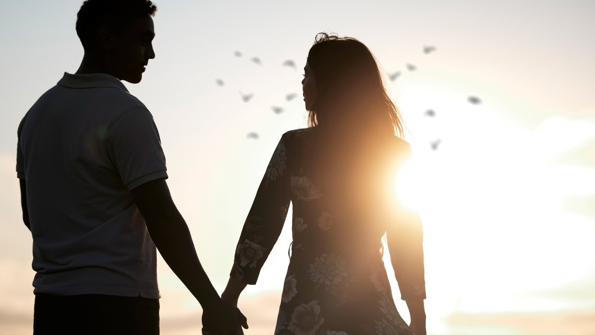 Couple, silhouette and holding hands at romantic, destination