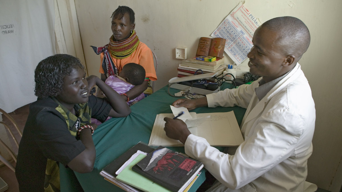 A doctor in Kenya counsels a woman about HIV