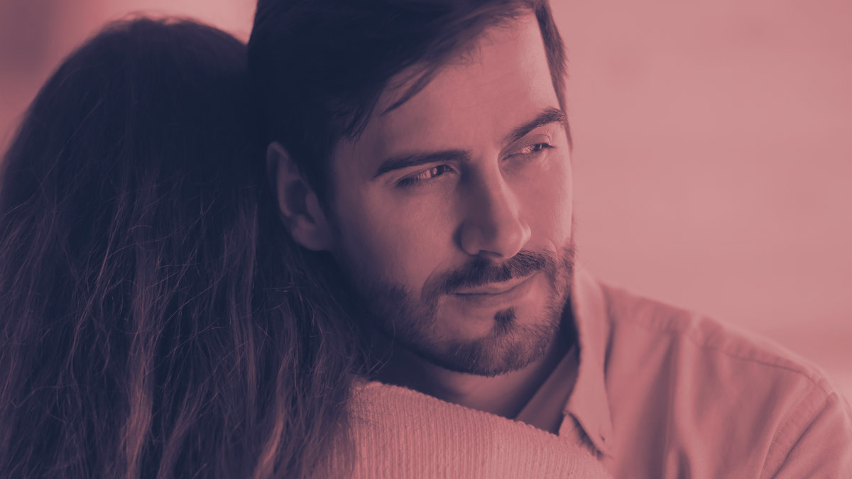 man distracted hugging woman