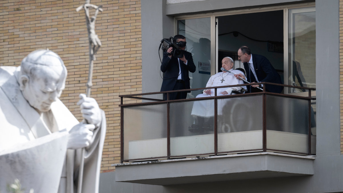 Pope Francis waves from a window of the Gemelli hospital before to be discharge after a five weeks hospitalization for pneumonia, in Rome on March 23, 2025