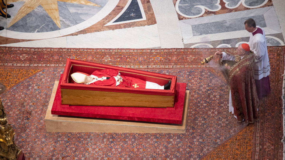Pallbearers carry the coffin of the late Pope Francis inside St Peter's Basilica as it is transported in a procession from the chapel of Santa Marta to St Peter's Basilica, following the Pope's death, in the Vatican on April 23, 2025.