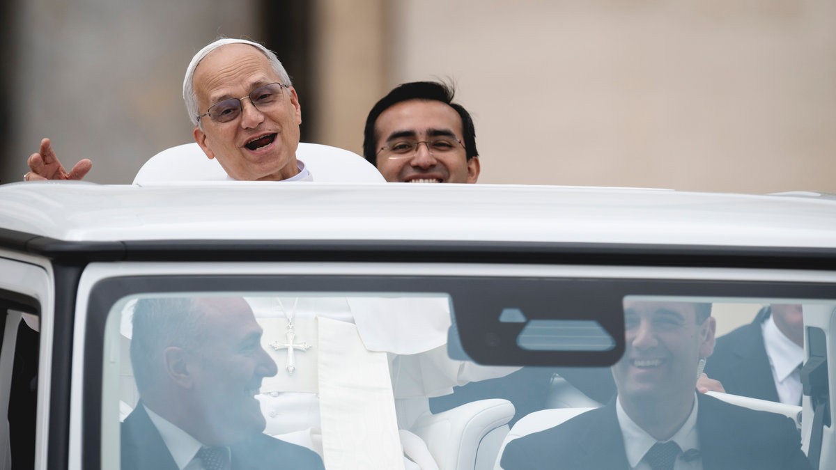 Pope Leo XIV with his personal assistant Edgard Ivan Rimaycuna Inga at the end of his first weekly general audience at St Peter's Square in The Vatican on May 21, 2025.