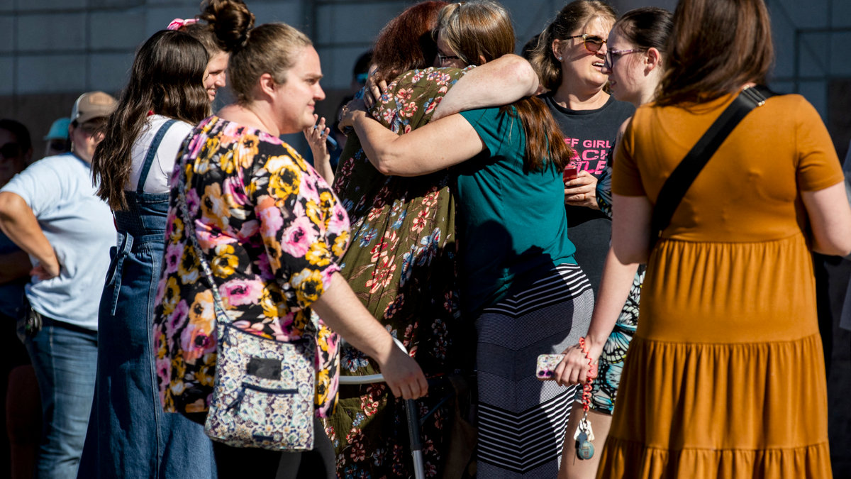 People hugging outside church