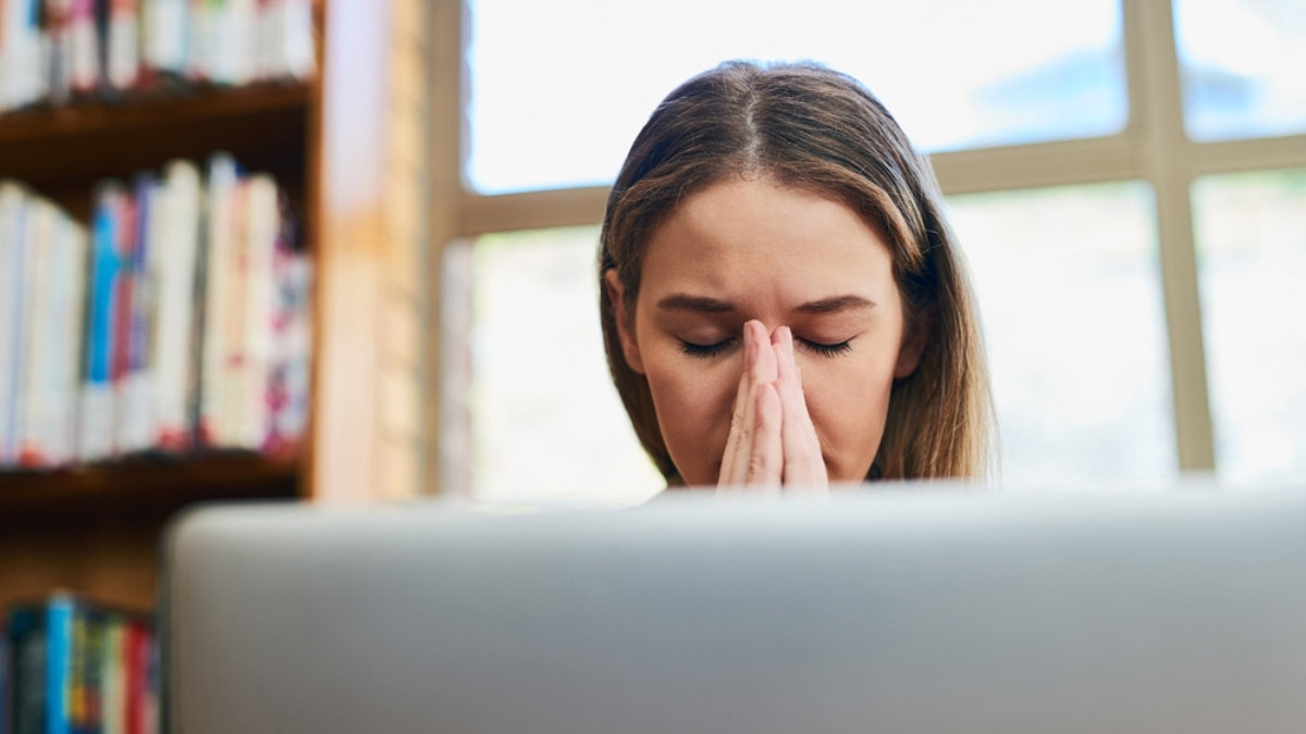woman praying in library