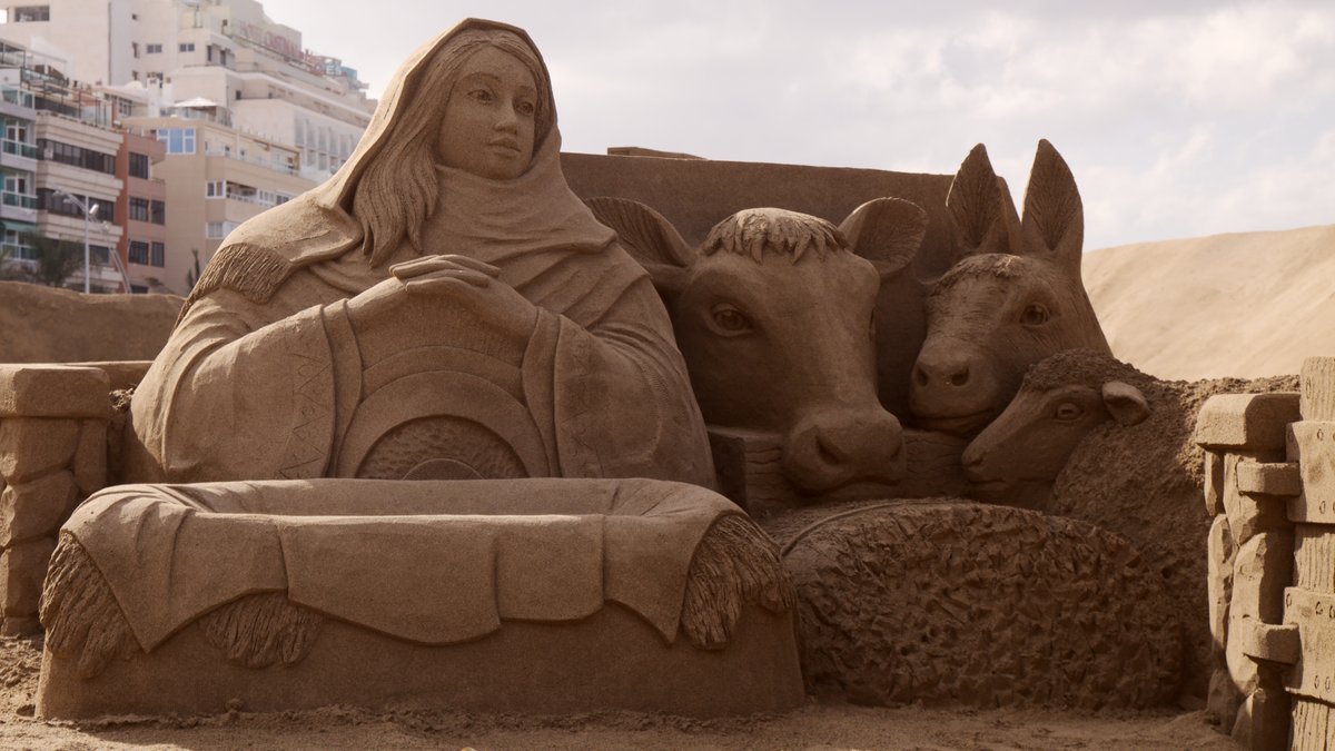 Las Palmas de Gran Canaria, Spain - December 13: Visitors admire Belen de Arena, Nativity scenes made of sand, on Las Canteras town beach, December 13, 2021 in Las Palmas de Gran Canaria, Spain