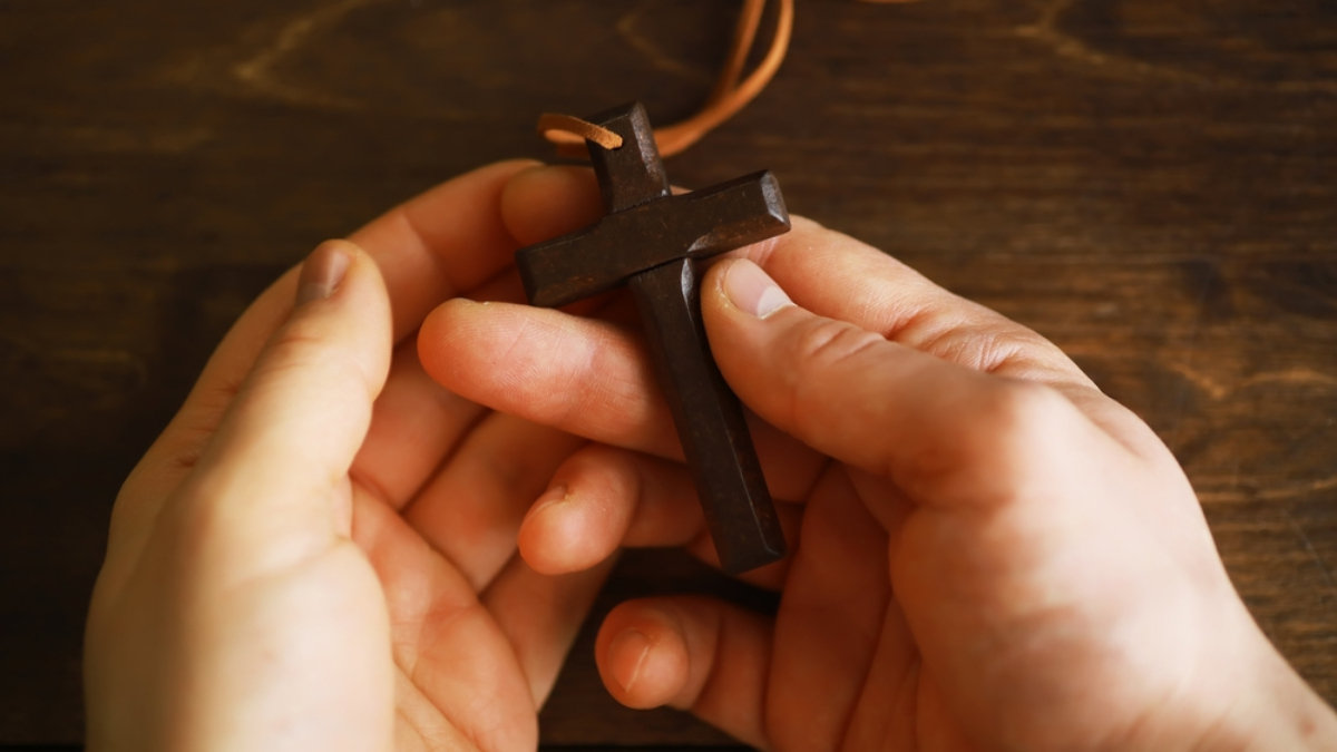 teen holding cross