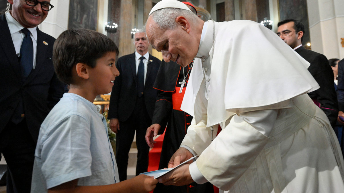 Pope Leo XIV greeting a kid during a meeting with Diocesan charity and welfare organizations in the Church of Sant Augusti in Montserrat