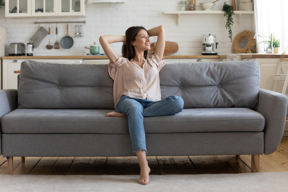 happy single woman on sofa
