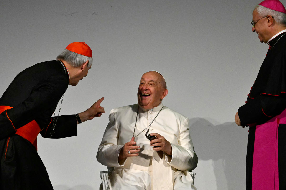 Pope Francis shares a laugh with Italian Cardinal Matteo Maria Zuppi