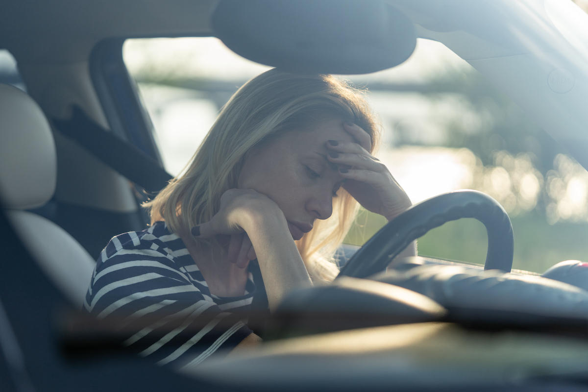 Depressed middle woman driver sitting inside car feeling doubtful confused about difficult decision suffering from personal psychological problem