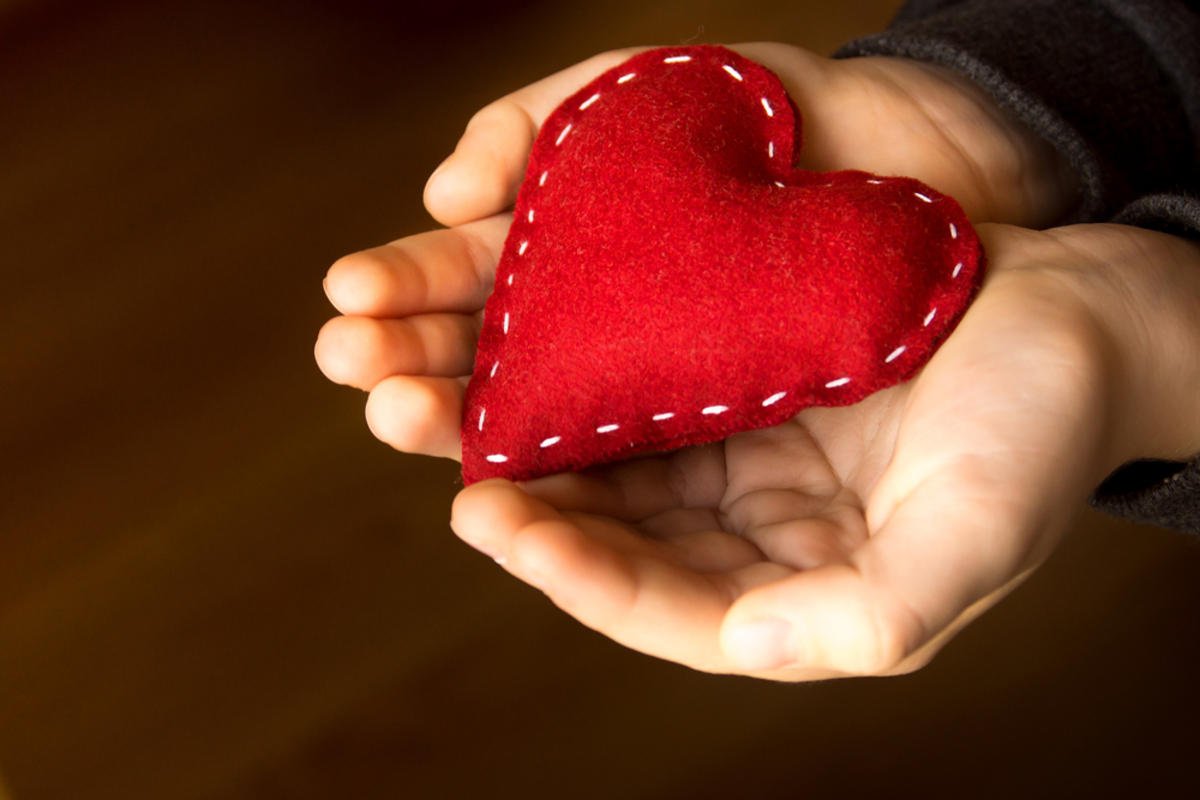 Red heart in child hands