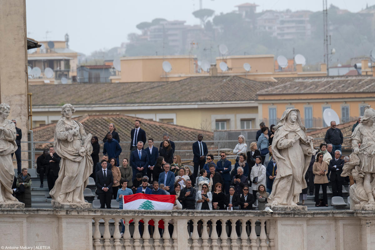 Pope Francis waves from the central loggia of St. Peter's basilica during the Easter 'Urbi et Orbi' message and blessing to the City and the World as part of the Holy Week celebrations