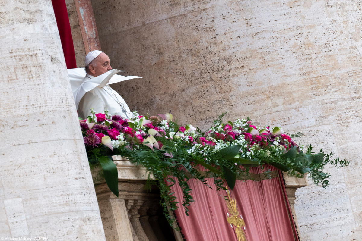 Pope Francis waves from the central loggia of St. Peter's basilica during the Easter 'Urbi et Orbi' message and blessing to the City and the World as part of the Holy Week celebrations