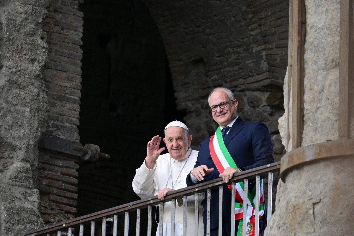 Pope Francis stands next to the mayor of Rome Roberto Gualtieri at a balcony overlooking the Roman Forum during a visit at Rome's City Hall on June 10, 2024.