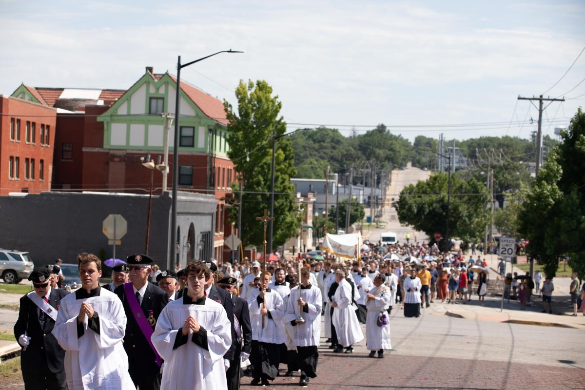 The National Eucharistic Pilgrimage walks up Fourth Street in Atchison, Kansas.