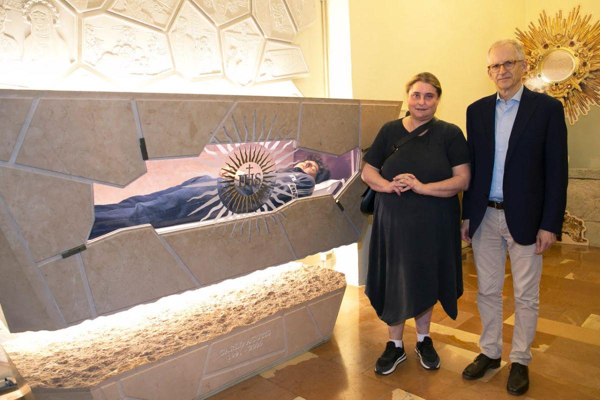 Carlo Acutis' parents standing next to his tomb in Assisi’s Shrine of the Renunciation, within the Church of St. Mary Major. 
