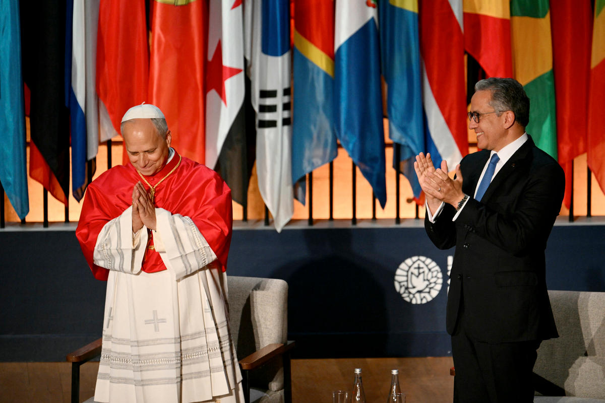 Pope Leo XIV reacts as UNESCO Director-General Khaled El-Enany applauds upon his arrival to deliver a speech at the UNESCO headquarters, in Paris on September 25, 2026 during his four days visit to France.