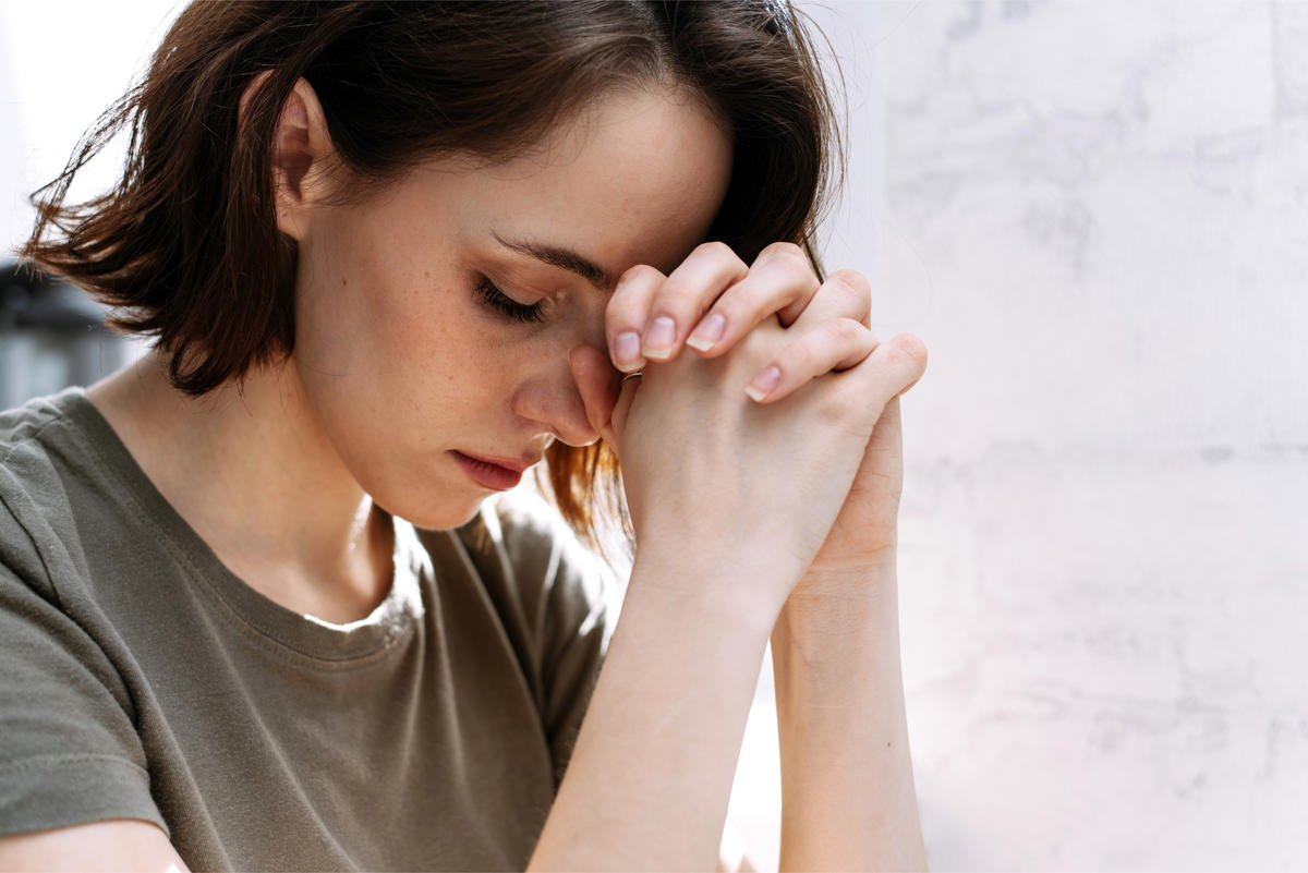WOMAN PRAYS,
