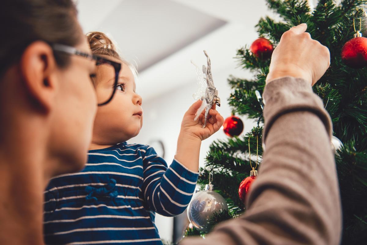 Mom and daughter decorating Christmas tree