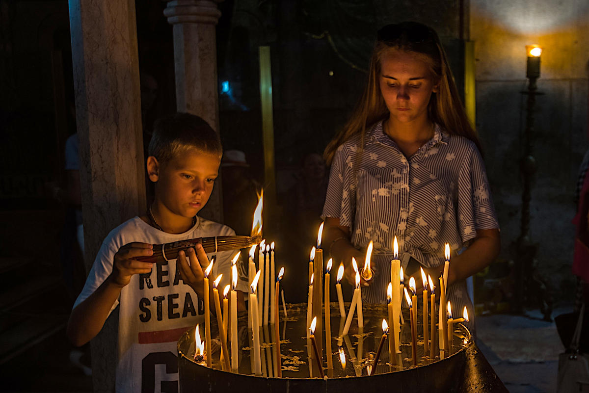 BOY LIGHTING CANDLE CHURCH OF THE HOLY SEPULCHRE