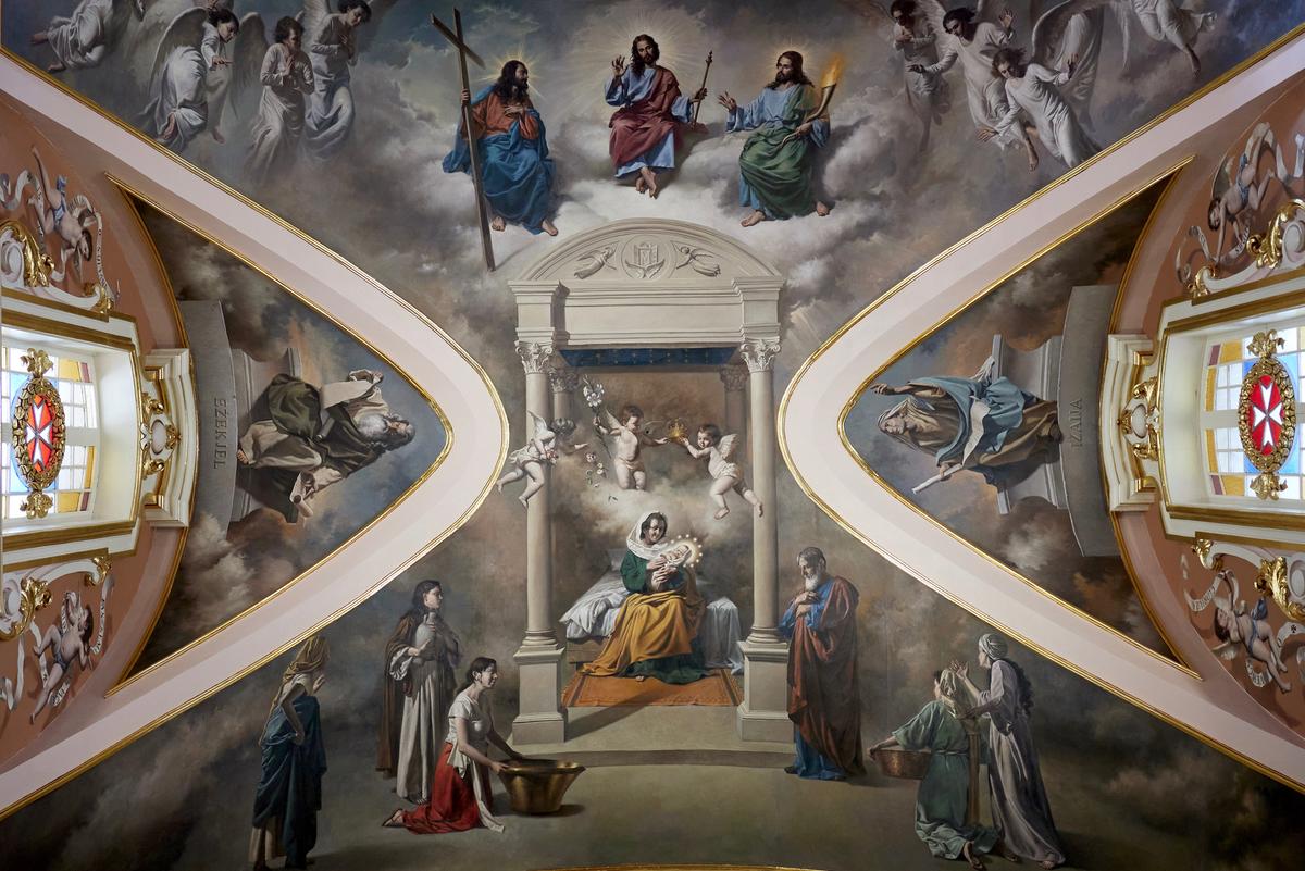 The choir painting of the Senglea Basilica by Manuel Farrugia (Phase 1 of the embellishment project. Lunette paintings by Frank Portelli). Mary’s Nativity is blessed by the Holy Trinity, and the new-born Mary is held in the loving arms of Saint Anne, and Saint Joaquin is seen contemplating beside them