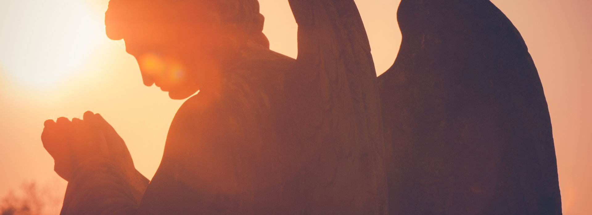 guardian angel sculpture at sunset