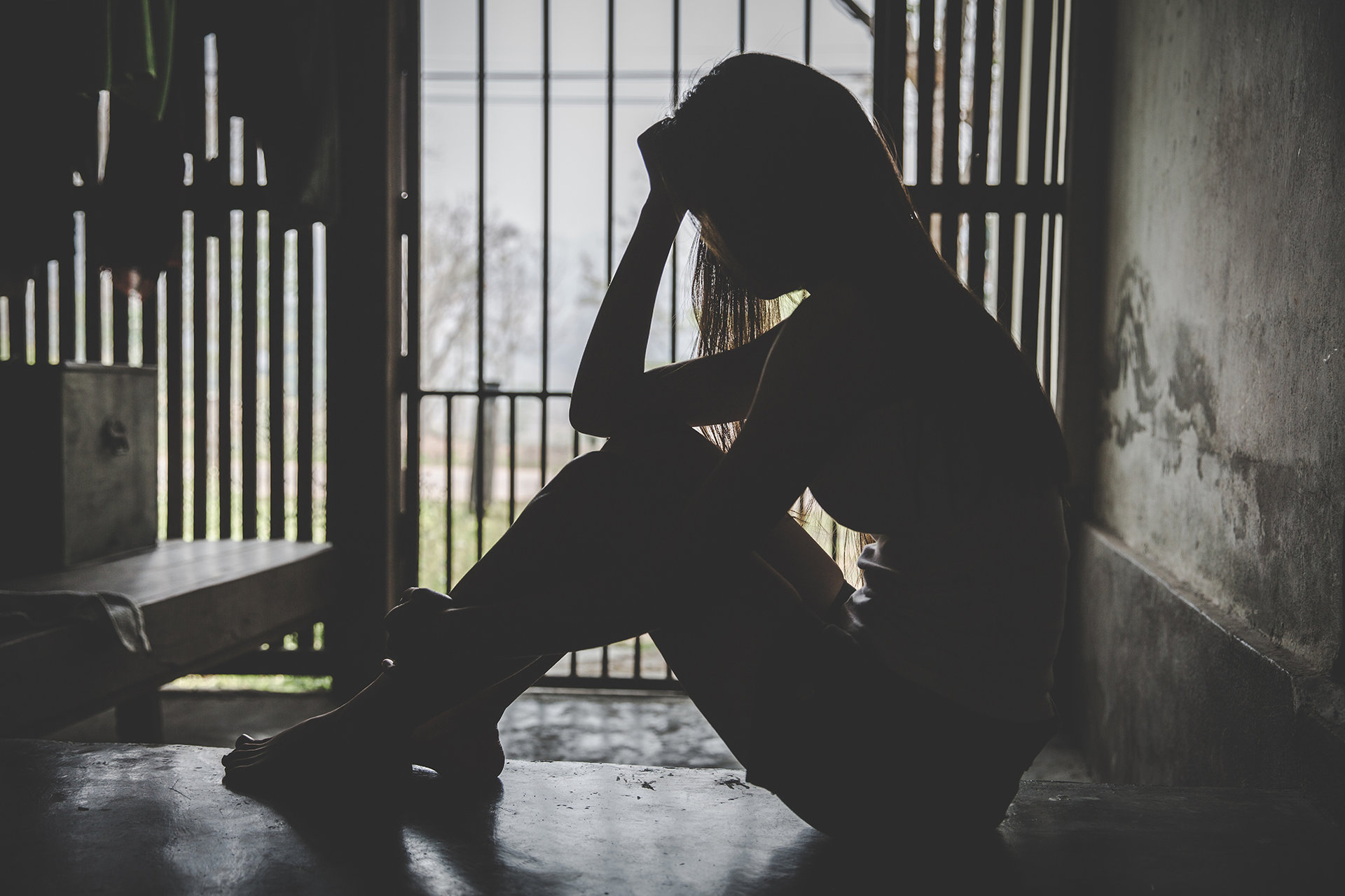 Desperate people are in a dark cell. Human trafficking, Stop abusing violence