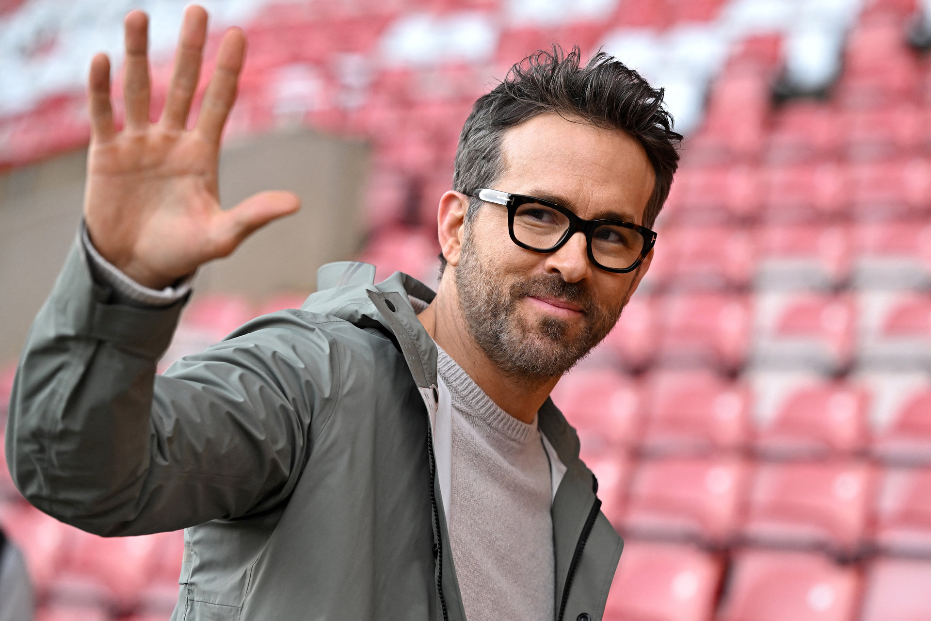 US actor and Wrexham owner Ryan Reynolds waves to fans ahead of the English FA Cup fourth round football match